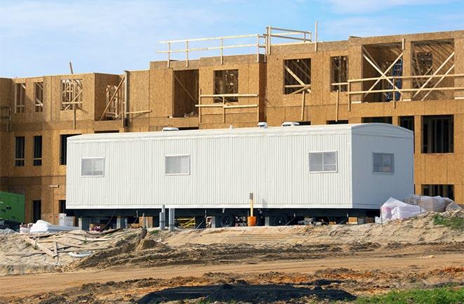 workers studying blueprints in a temporary rental office in Winter Springs